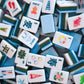 Collection of colorful Mahjong tiles on a white surface/lake inspired